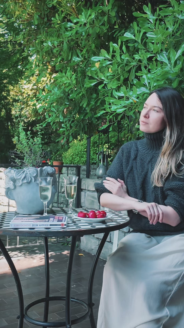 Short video of model wearing Dino Cashmere Pullover strolling through a Como garden.